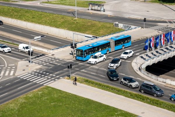 Aerial shot of a bustling traffic intersection with cars and a bus in Zagreb, Croatia.
