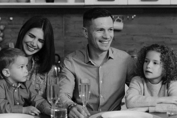 Smiling family enjoying quality time together at dining table in cozy kitchen.
